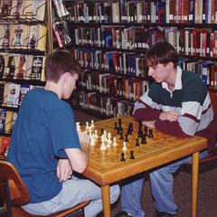 Two students playing chess, Janesville, ca. 1990