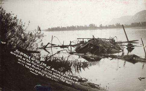The wreck of the Str. J.S. burned June 25, 1910, now lying in the Mississippi River north of Victory, Wis. Over 110 people escaped from this boat, with the loss of only two lives.