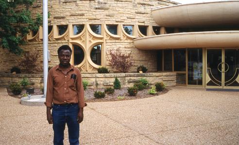 Folarin in front of building