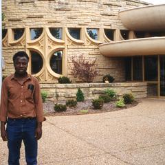 Folarin in front of building