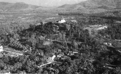 Aerial view of Luang Prabang depicting Phu Si monument on top of hill, main street of town below