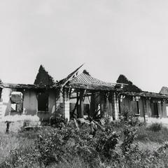 War damage to a government building in Saravan town during fighting of June 1970