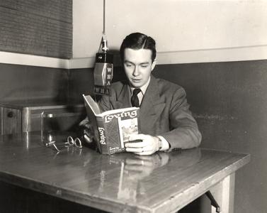 Karl Schmidt reading a book at microphone