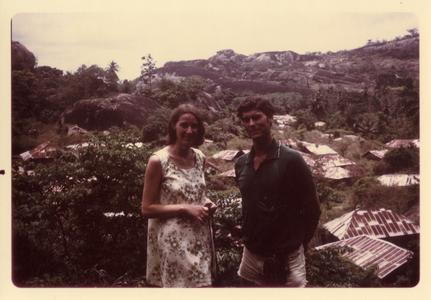 Woman and man with village view in background