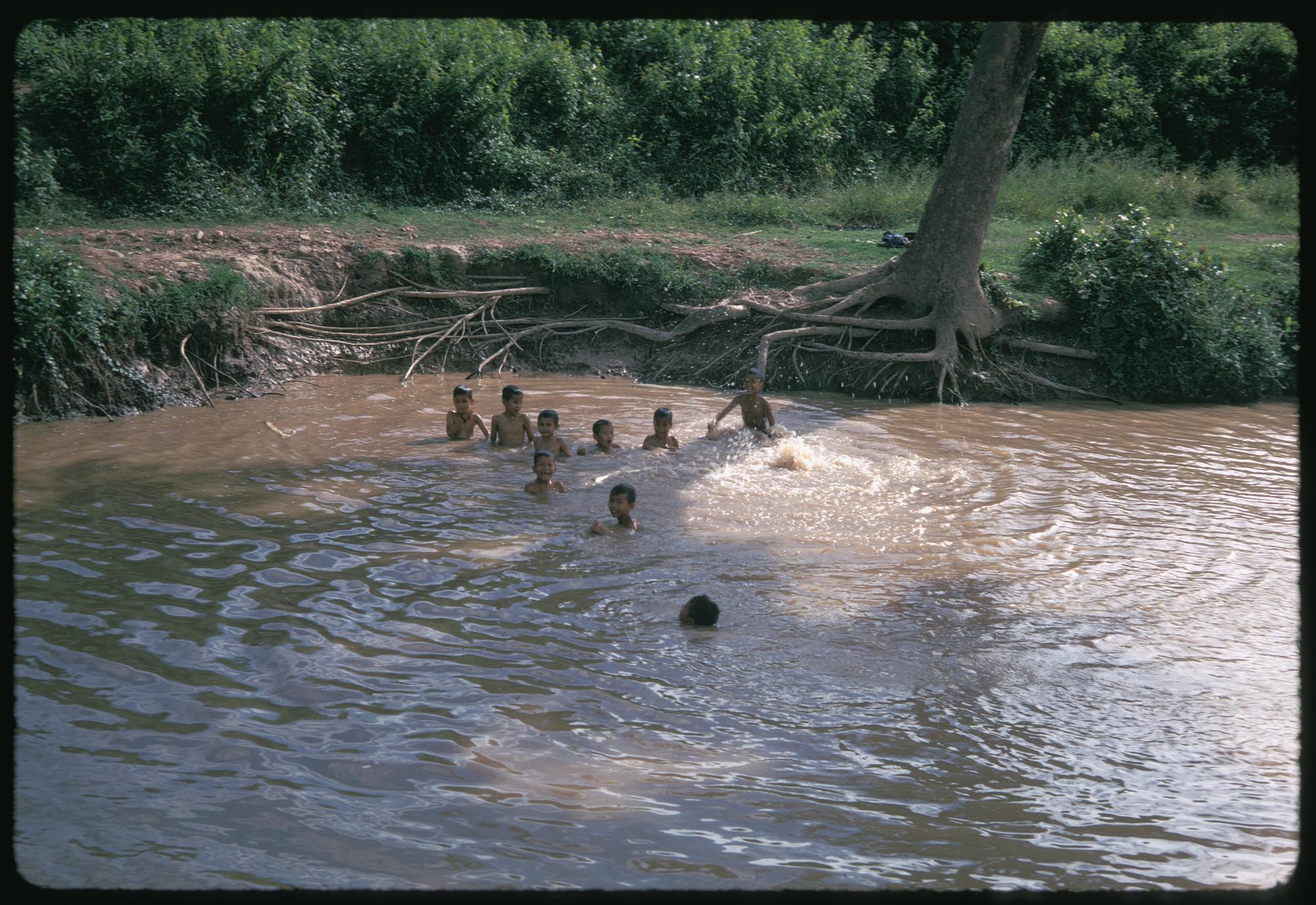 Tai Dam village children swimming in stream - UWDC