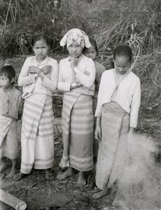 Three White Lahu (Lahu Hpu) girls stand in a village southwest of Muang Meung in Houa Khong Province