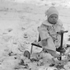 Child on trike in snow
