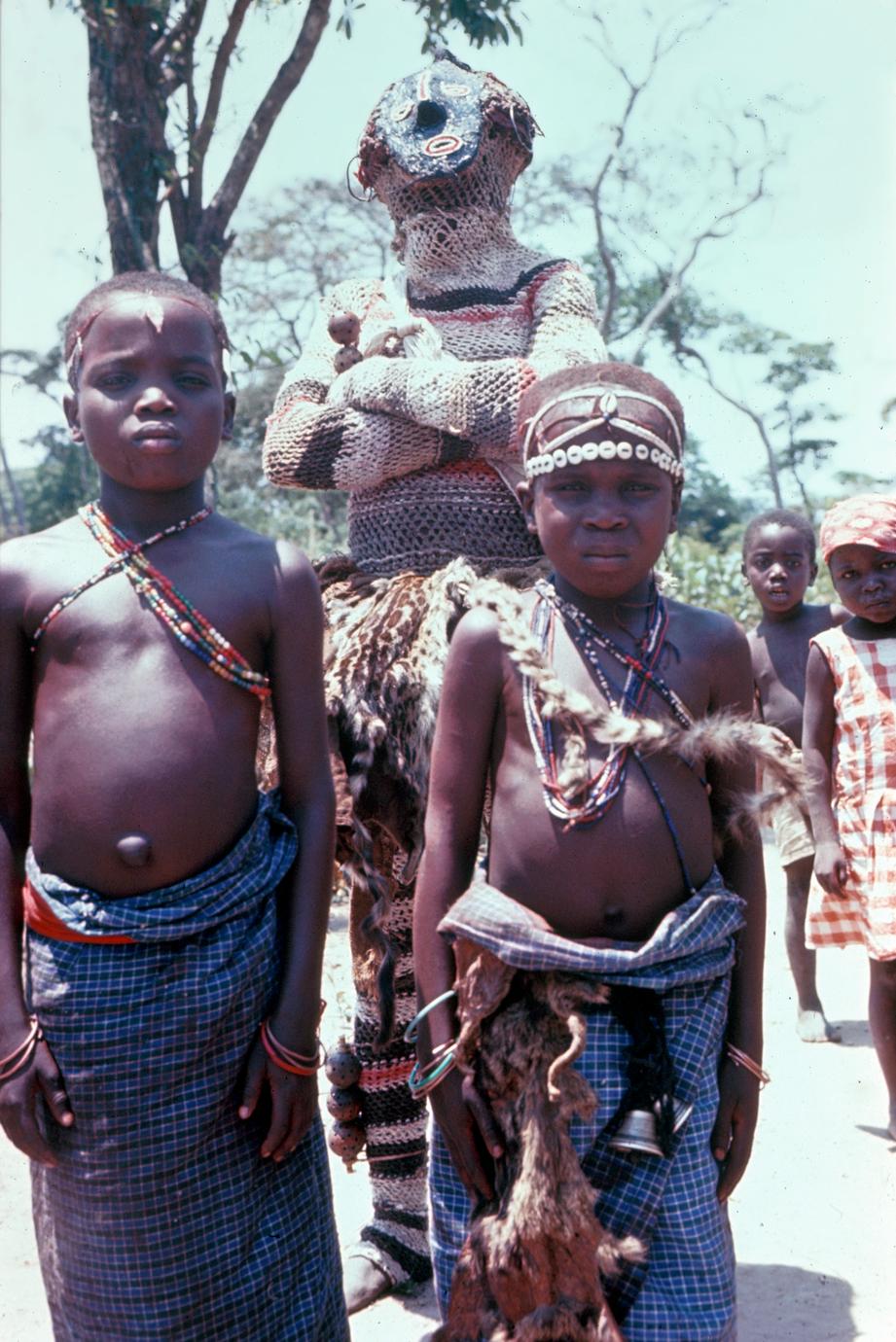 A Cokwe Maske Dancer with Mbondo Boys