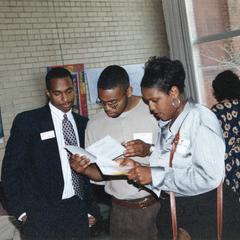 Students read program at 1995 graduation reception