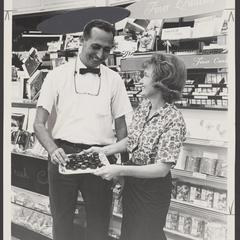 A customer samples candy in a drugstore