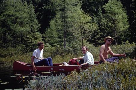 Students in canoes on edge of bog mat
