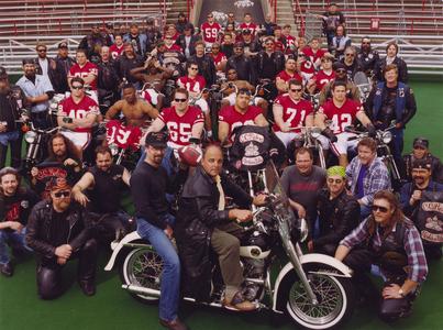 Barry Alvarez and football players on motorcycles