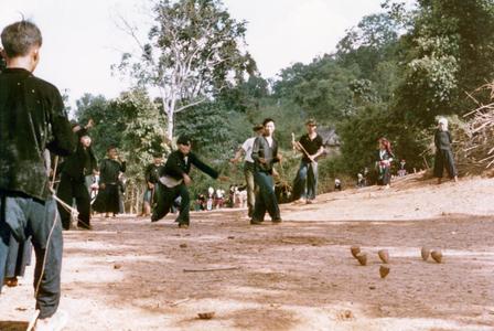 White Hmong boys playing tops in the village of Nam Phet in Houa Khong Province