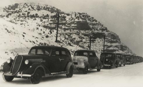 Nash automobiles transported by highway through a mountain pass