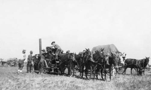 Soldiers of the US Army's 15th Infantry Regiment unloading cargo from horse-drawn cart.
