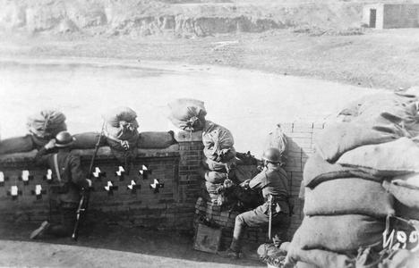 Two fully armed Japanese soldiers guarding a fortification.