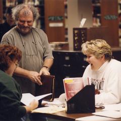 Theatre professor Brad Ford with students in library