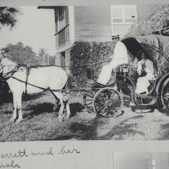 Mrs. Barrett and her pets inside a horse-drawn carriage