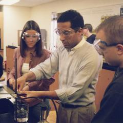 Chemistry professor Mohamed Ayoub with students in lab