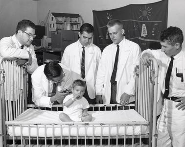 Doctors examine a small boy