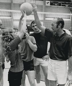 Coach showing a player how to properly set a volleyball