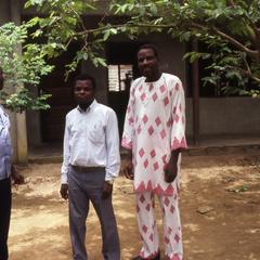 Three men in front of building