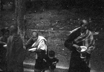 Woman providing food for monks