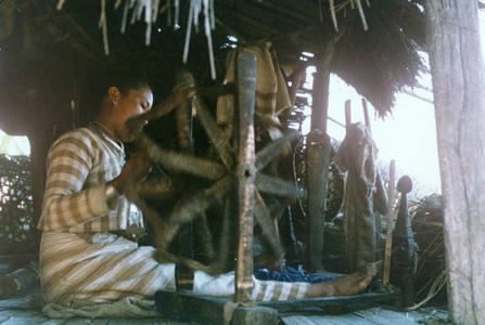 A White Lahu (Lahu Hpu) woman spins threads in the village of Chalopha in Houa Khong Province