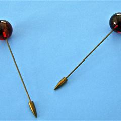 Two brown hatpins