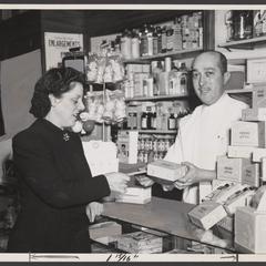 A woman receives baby products from a pharmacist