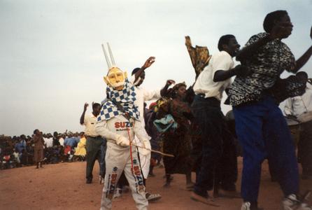 Mask Dancer and Other Dancers in Markala Stadium