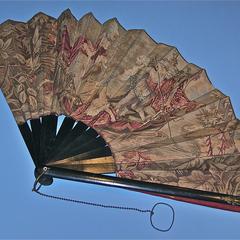 Fabric fan with two women and a man in a boat