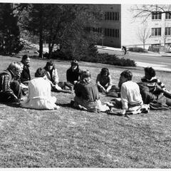 Students sitting on the lawn of the home economics building
