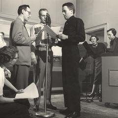 Radio players at microphone with scripts