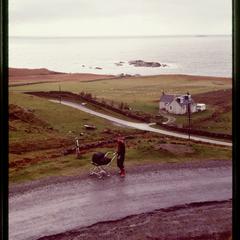 Quiet road and woman with pram, the Isle of Mull