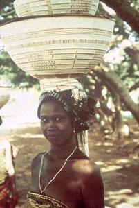 Young Woman Carrying Milk Curds and Sorghum Flour in Carved Calabashes