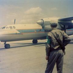 The aircraft carrying Prince Souphanouvong taxies to a halt with Pathet Lao policemen at the Luang Prabang airport
