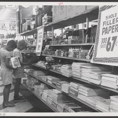 Young boys examine merchandise in a drugstore display