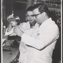 Pharmacy staff prepare a liquid mixture
