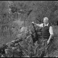 Williamson standing by a stone dyke in Argyll he helped to build when in his teens