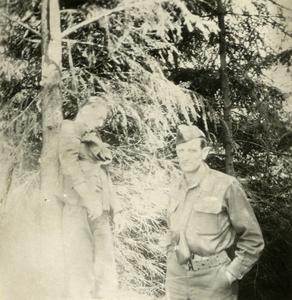 American GI gets his picture taken with dead German soldier
