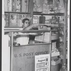 Clerk reads the scale at the drugstore's post office substation