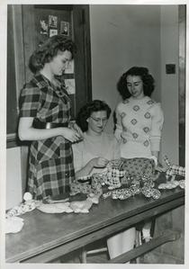 Young Women's Christian Association members sewing Christmas toys