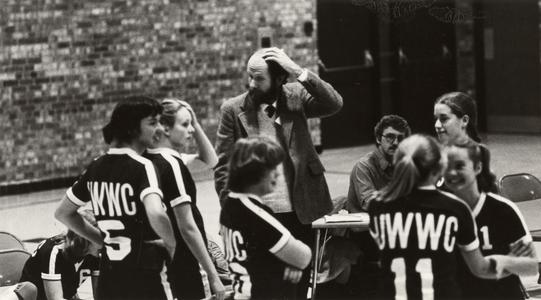 Coaches Clair Bigler and Tom Brigham during a women's volleyball match