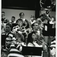 Stout Pep Band playing in the bleachers at a men's basketball game