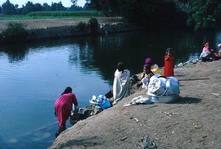 Washing Dishes and Laundry in a Nile River Canal