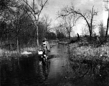 Aldo Leopold and Flick walking down flooded Levee Road