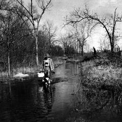 Aldo Leopold and Flick walking down flooded Levee Road