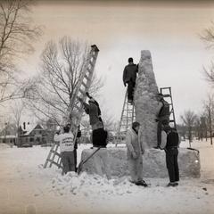 Students with ladders building a snow sculpture