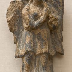 Fragment of a Relief with a Standing Winged Female Figure Playing a Flute